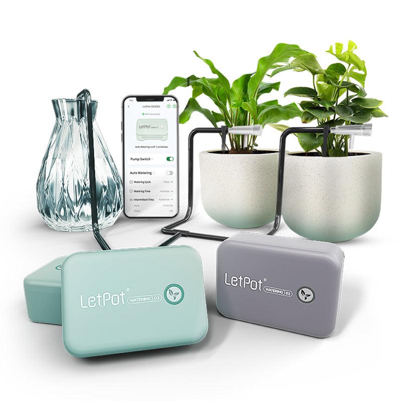 Automatic indoor plant watering system with smartphone app, water reservoir, and two potted plants